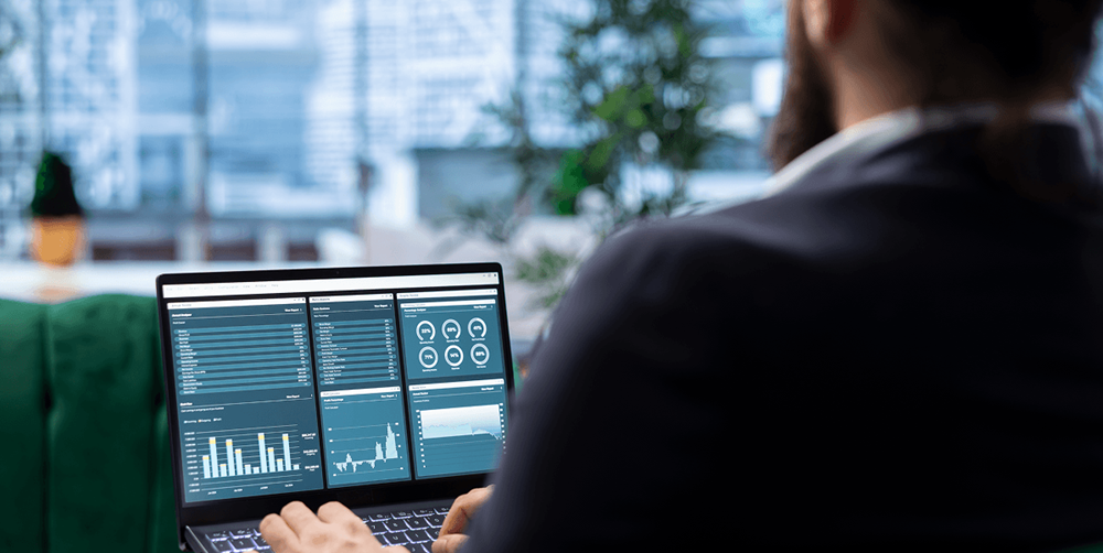 Restaurant operator reviewing menu performance data and sales analytics on a laptop dashboard