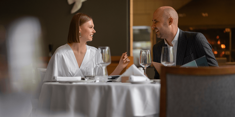 Two guests enjoying a fine dining experience at a modern restaurant