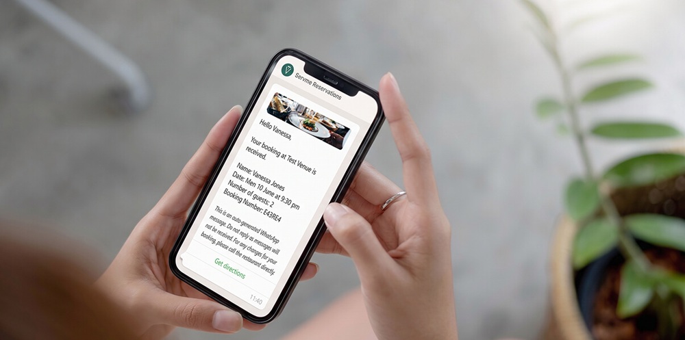 WhatsApp booking confirmation from Servme Reservations showing guest name, date, cover count, and booking number — an example of an automated reservation message sent from a restaurant's branded sender name.