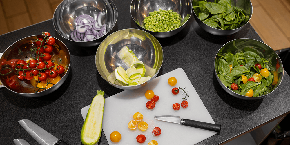 Prepped ingredients portioned ahead of service, showing how overproduction at this stage is one of the leading causes of food waste in restaurant kitchens.